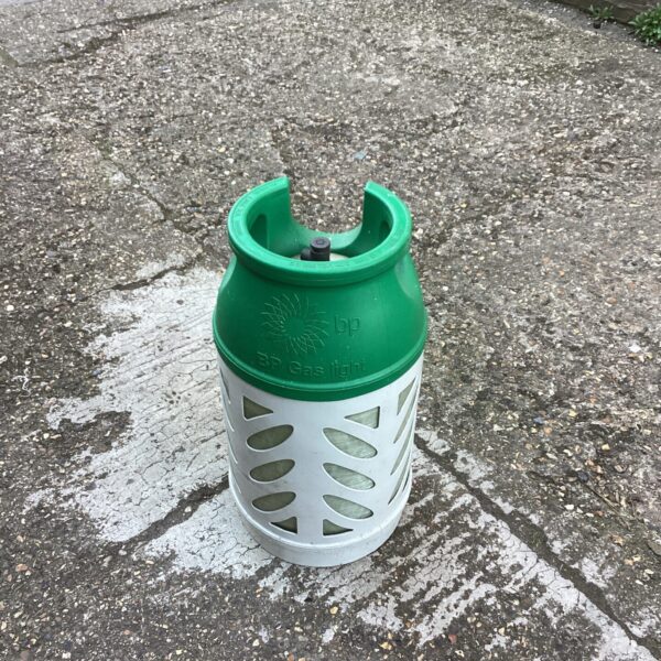 Green helium gas bottle with protective cage.
