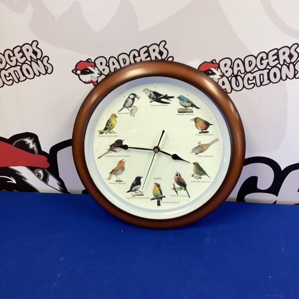 Vintage quartz wall clock with colourful bird illustrations.