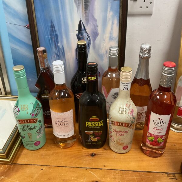 Mixed alcohol lot featuring Baileys and Passoa bottles.