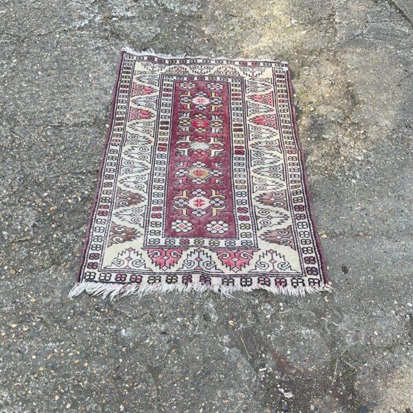 Vibrant small Moroccan rug with traditional Berber geometric patterns.