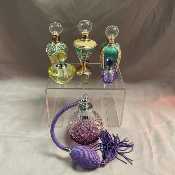 Vintage perfume bottles and atomiser, antique scent collection.