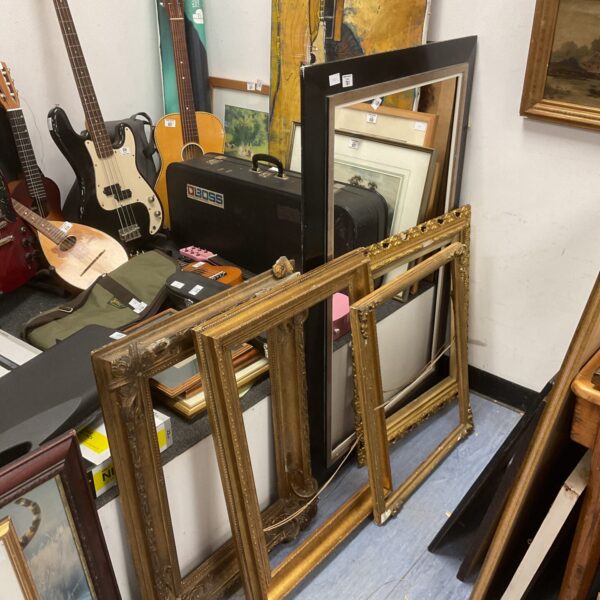 Lot of five vintage gilt picture frames with ornate detailing.