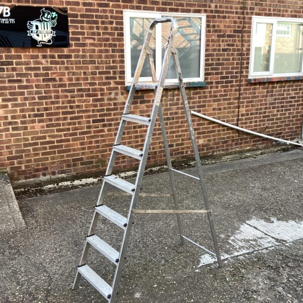 Silver Youngman 7ft aluminium step ladder against a brick wall.