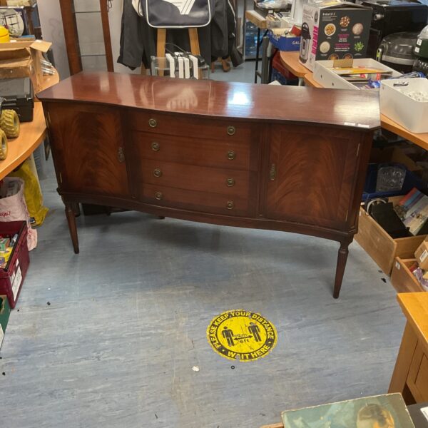 Front view of a vintage mahogany sideboard with drawers.