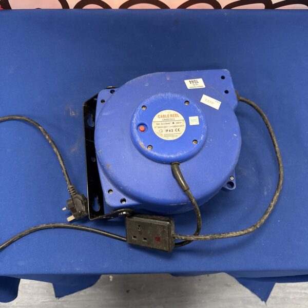 Vintage single gang wall mounted cable reel for workshop use.