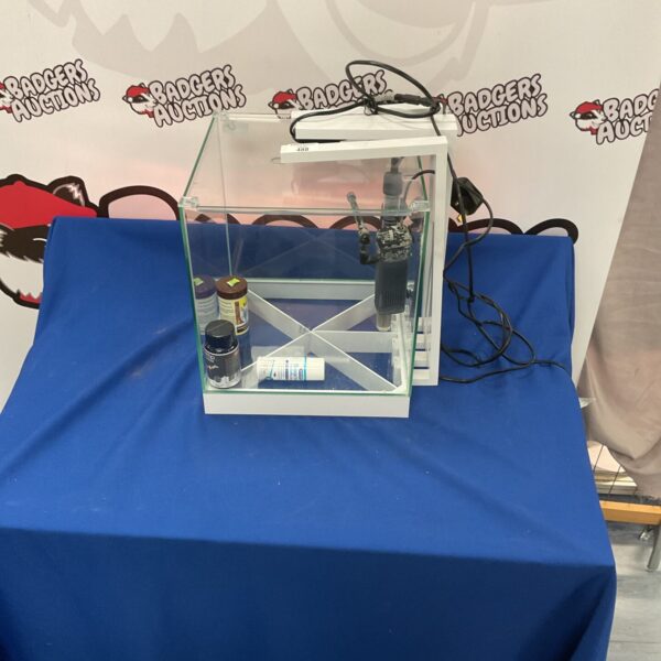 Small glass fish tank with pump for desktop aquariums.