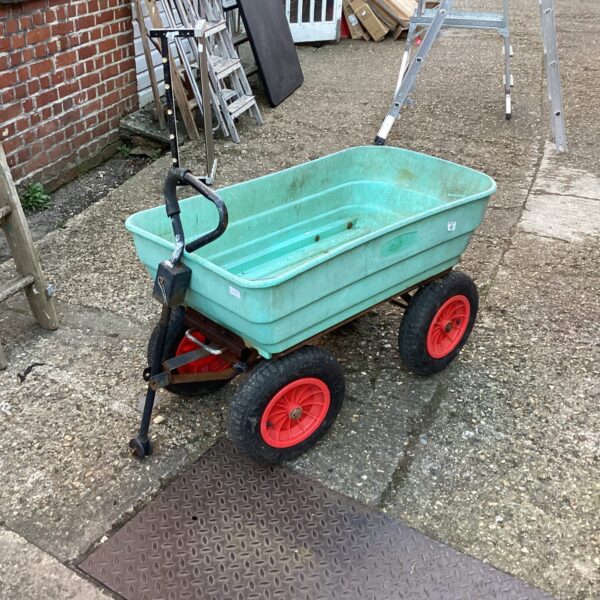 Green garden cart with two wheels for outdoor use.