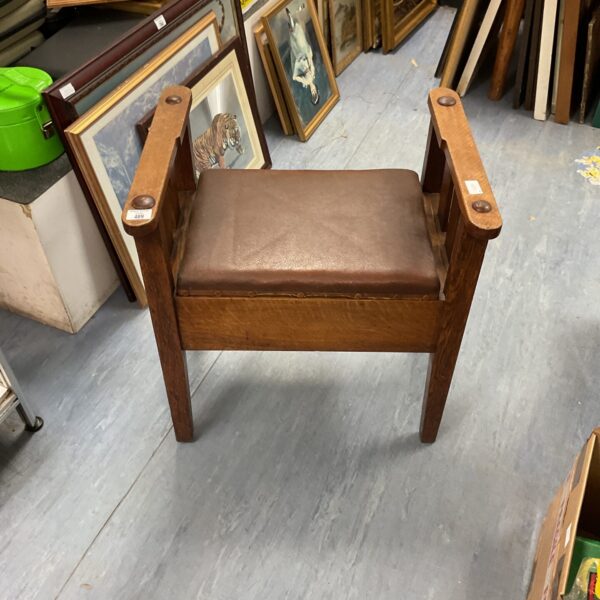 Antique piano stool with leather seat and oak frame.