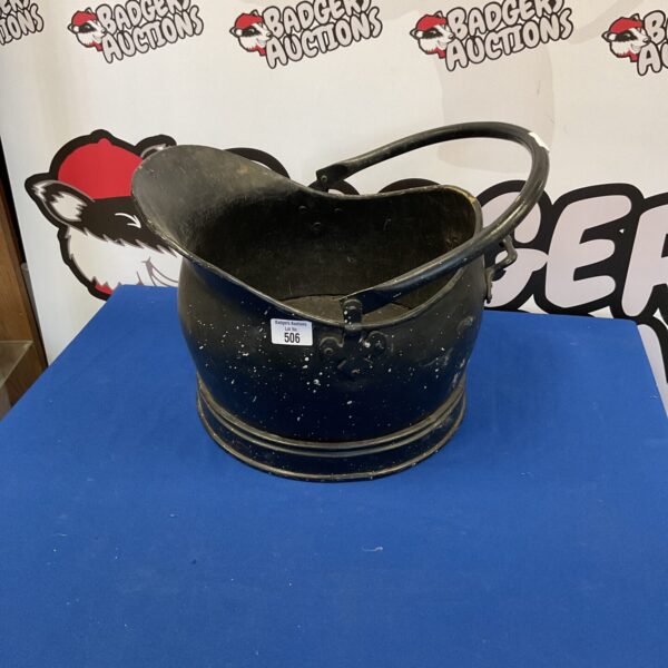 Vintage brass coal scuttle with handle, antique fireplace accessory.
