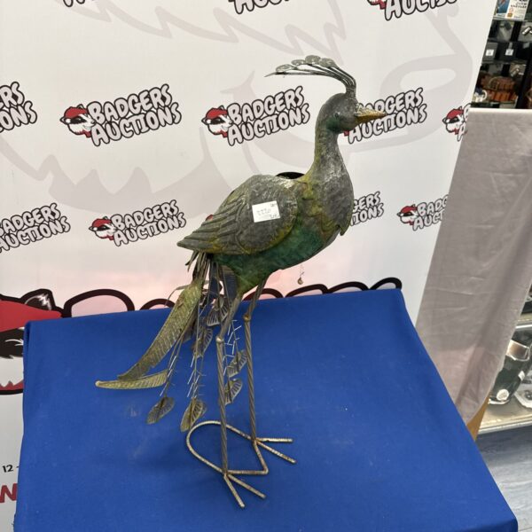 Vintage metal peacock garden ornament, detailed metal sculpture.