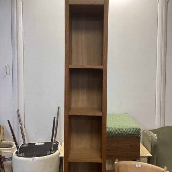 Tall wooden CD storage rack for media collections.