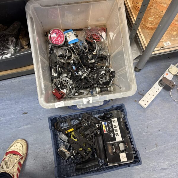 Assorted bicycle parts in a plastic container, ideal for repair.