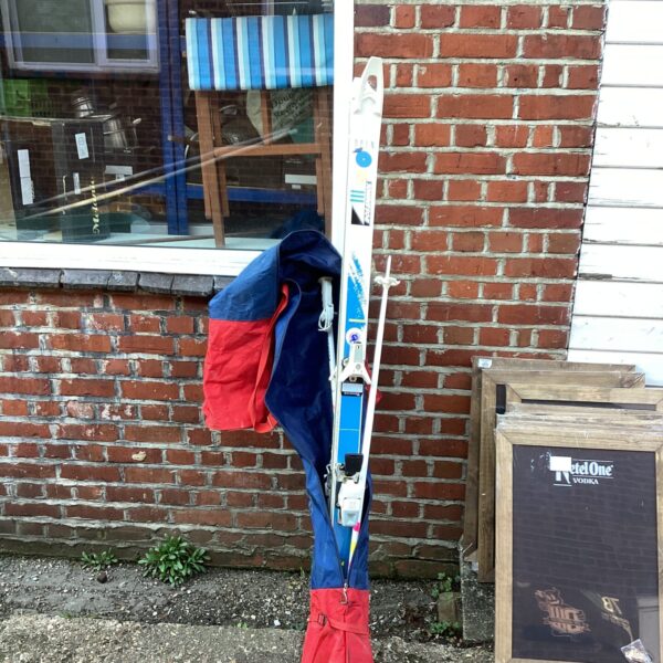 Vintage Rossignol ski set with red cover.