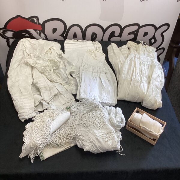 A lot of antique Victorian christening gowns with lace details.