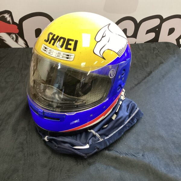 Vintage Shoei Eagle motorcycle helmet in yellow and blue.