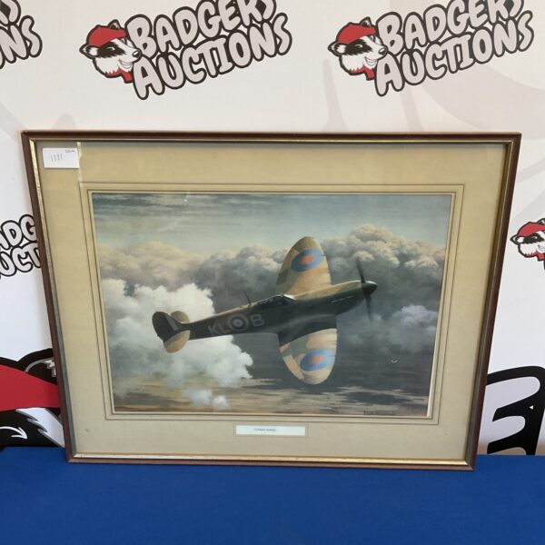 Framed Keith Woodcock print of a Spitfire aircraft in flight.