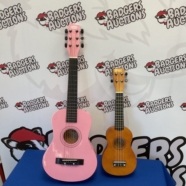 Pink child's acoustic guitar and ukulele set for young musicians.
