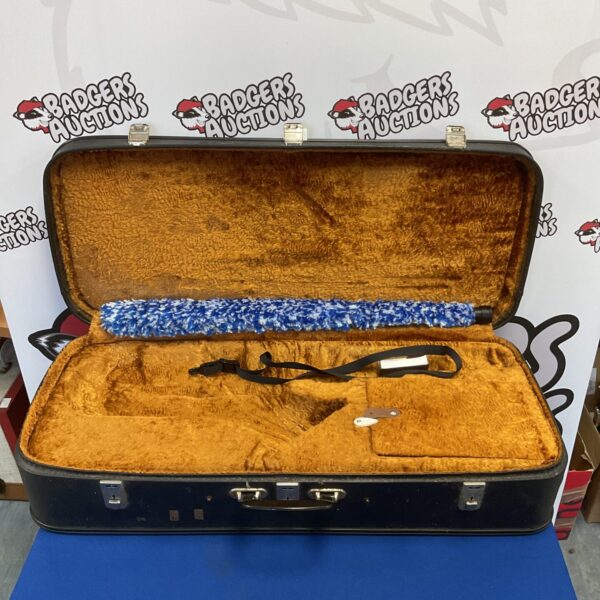 Vintage lined saxophone case for musical instrument storage.