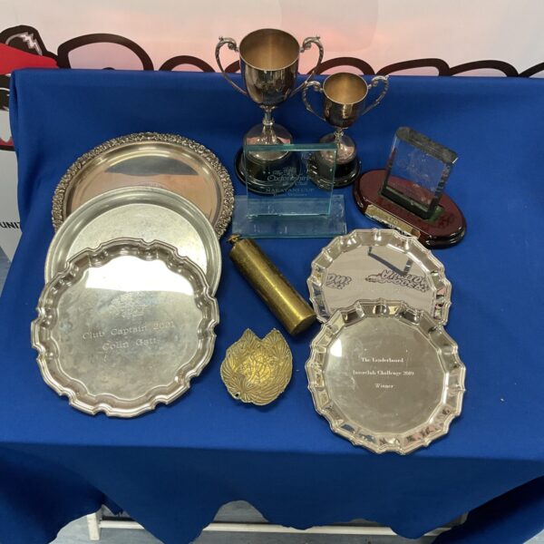 Vintage golfing trophies and awards collection on display.