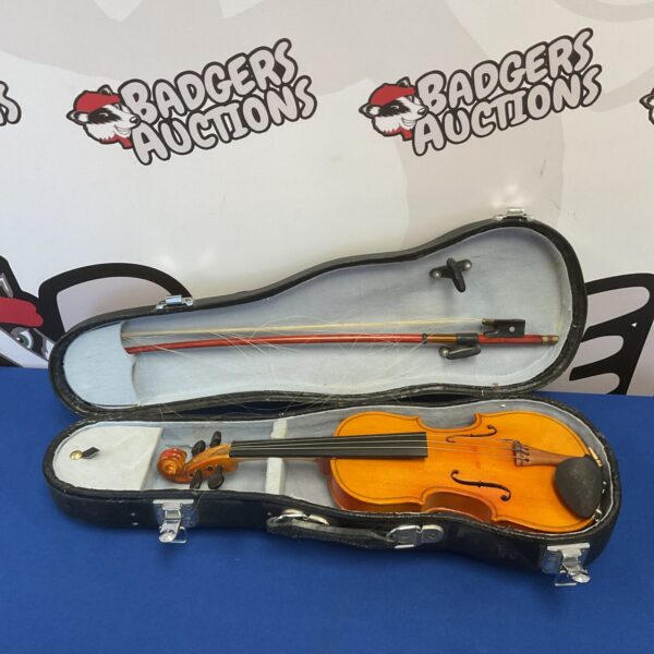 Small child’s violin with bow inside a protective case.
