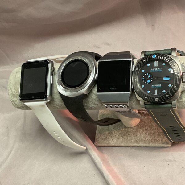 Smart watch lot featuring Panerai, Fitbit, and Apple Watch.