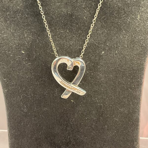Vintage Tiffany 925 silver necklace on a neutral background.