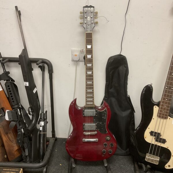 Red Samick electric guitar, vintage musical instrument, detailed view.