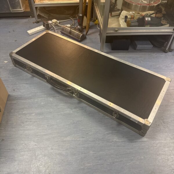 Black transit case with padded lining, ideal for instrument transport.