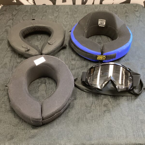 Racing neck brace and goggles lot for motorsport safety.