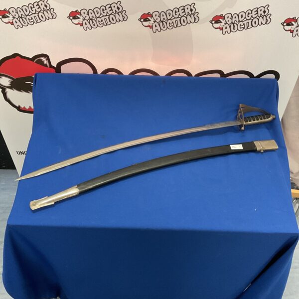 Antique Indian ceremonial sword with curved blade and ornate hilt.