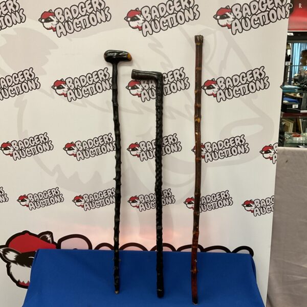 Lot of three vintage wooden walking sticks.
