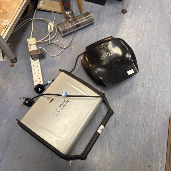 Two George Foreman grills on a blue floor.