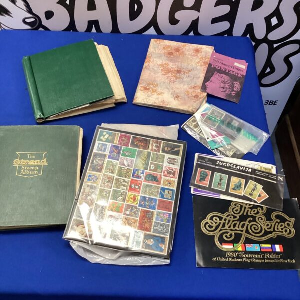 Vintage stamp albums with a diverse collection of stamps inside.