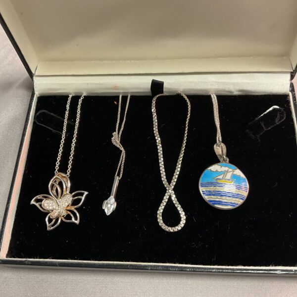 Silver necklace with a cubic zirconia flower pendant.