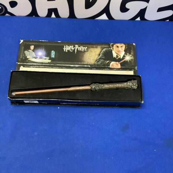 Dark-toned Harry Potter replica wand on display.