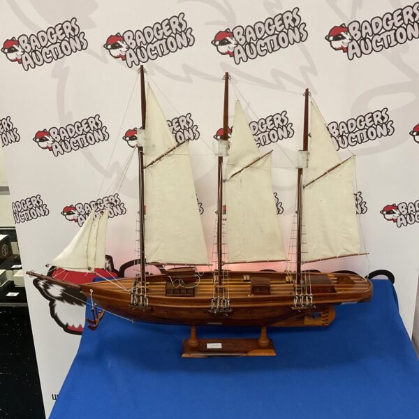 Detailed wooden schooner model boat for nautical display and collecting.