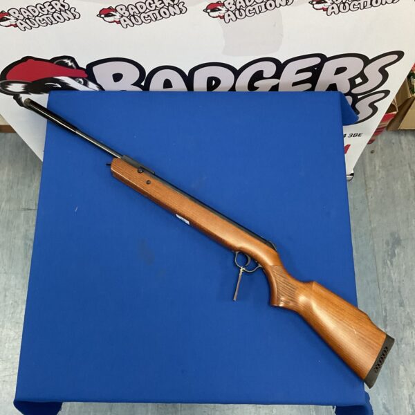 Walther 5.5mm air rifle on a blue backdrop.