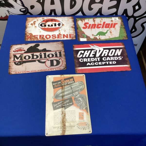 Collection of vintage reproduction gas and oil advertising signs.