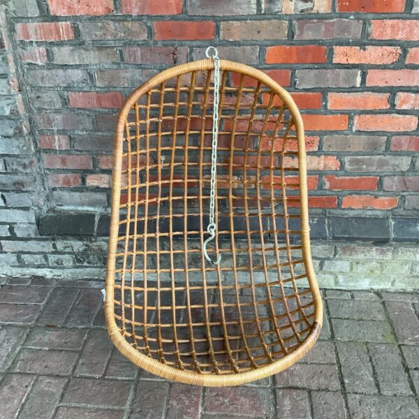 Vintage bamboo garden swing seat for outdoor relaxation.