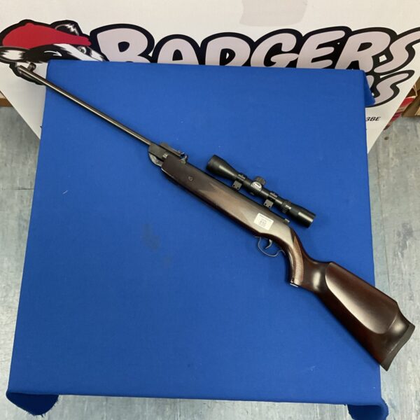 SMK XTB2-2K .22 air rifle with scope on blue backdrop.