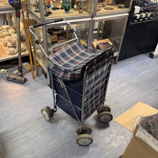 Vintage granny shopping trolley with blue and white pattern.