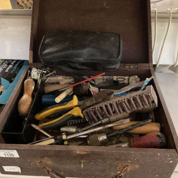 Vintage wooden tool case with tools inside, showing wear and tear.