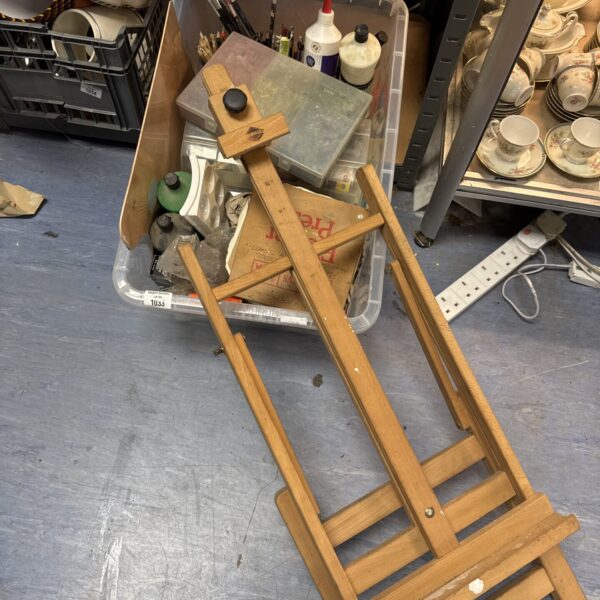 Mixed lot of art supplies with a small easel visible.