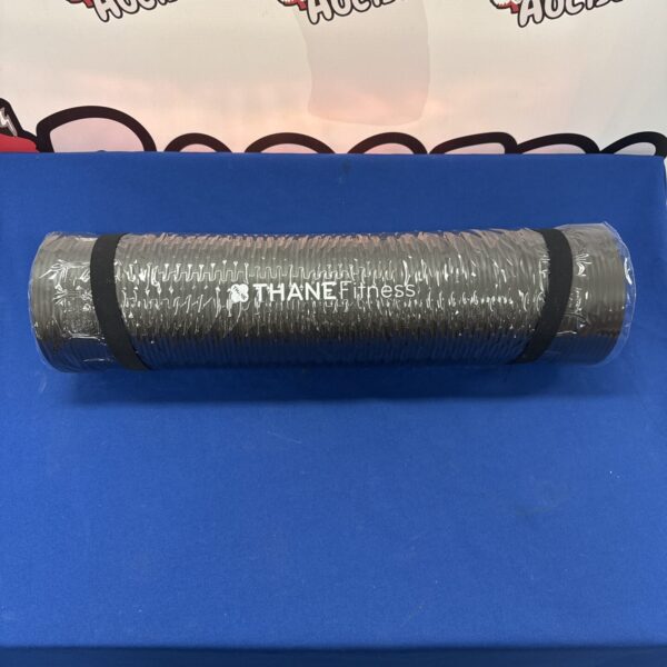 Thane Fitness yoga mat, rolled out for exercise.