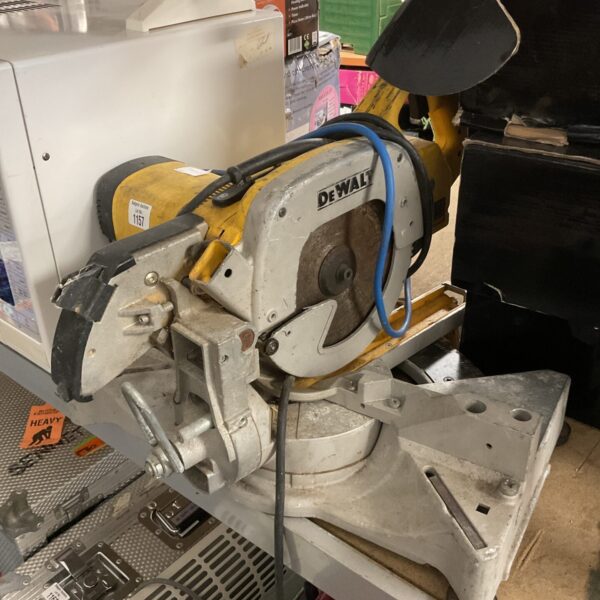 Used Dewalt 110v chopsaw for metal cutting in workshop setting.