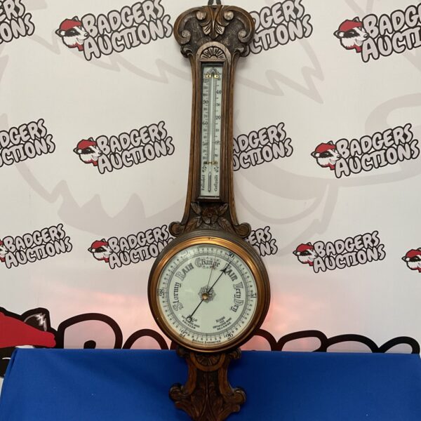 Antique carved oak aneroid barometer with weather dial.