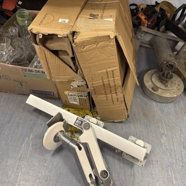 Used Humanscale monitor stand with boxes in background.