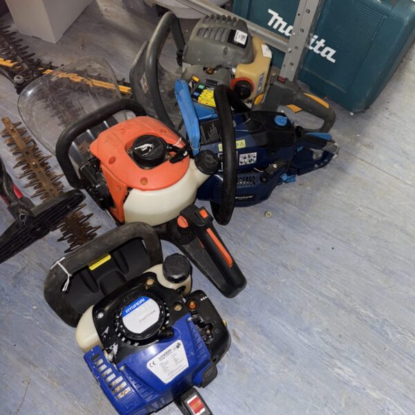 Lot of three petrol hedge cutters and a chainsaw engine.