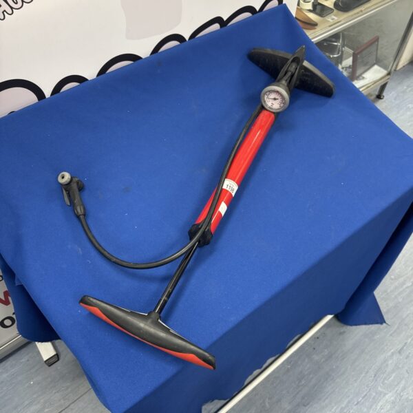 Vintage bicycle pump with stirrup base and pressure gauge.