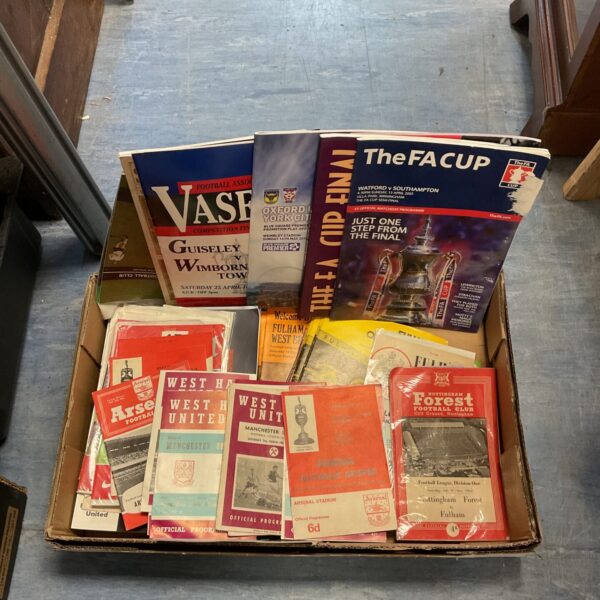 Vintage football programs including Arsenal and West Ham United.